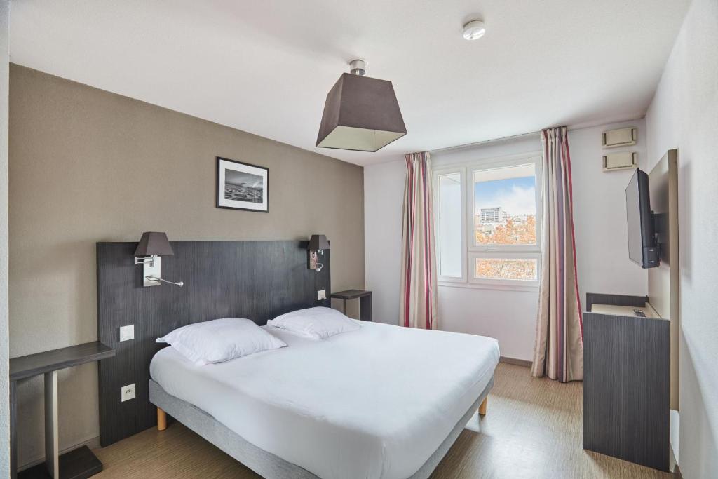 Ένα ή περισσότερα κρεβάτια σε δωμάτιο στο Appart Hotel Odalys City Marseille Le Dôme