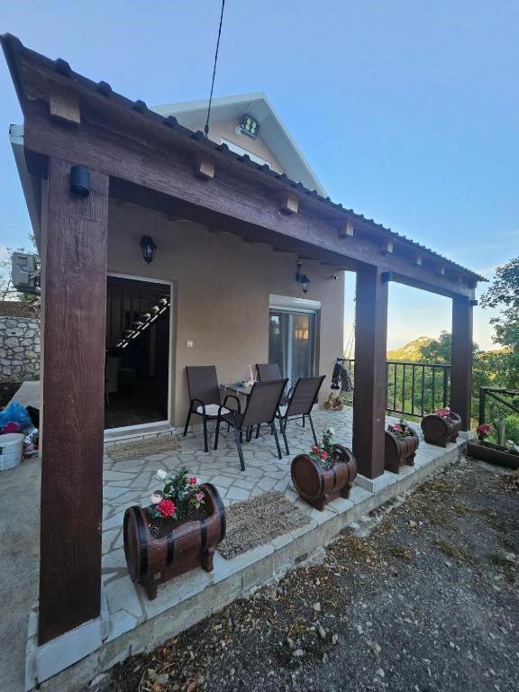 a house with a patio with a table and chairs at Village Drago in Cetinje