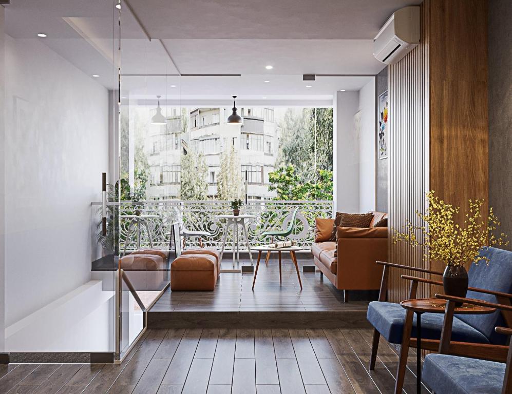 a living room with a table and chairs at ZODY Boutique Hotel in Ho Chi Minh City