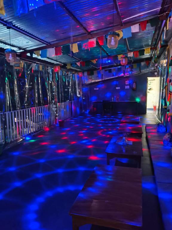 a dance floor with blue lights in a room at White Mountain By Pahadi Adda in McLeod Ganj