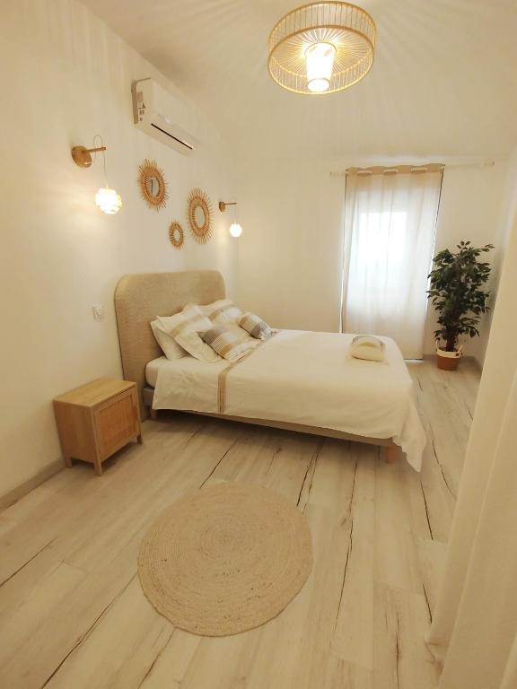 a bedroom with a large bed and a wooden floor at Les Gites d'Andréa- Chez les Fifou in Surba