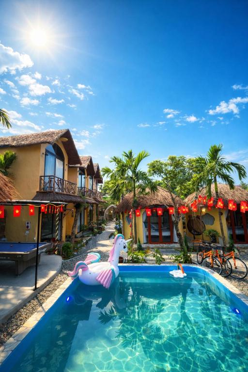 a pool at a resort with an inflatable unicorn in the water at Sora Traditional Homestay in Ninh Binh
