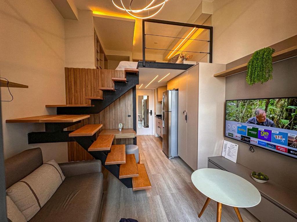een woonkamer met een trap in een huis bij Espaço Versa Brooklin in Sao Paulo