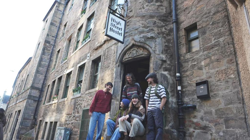 a group of people standing in a doorway of a building at High Street Hostel - Over 18s Only, Backpackers Atmosphere in Edinburgh