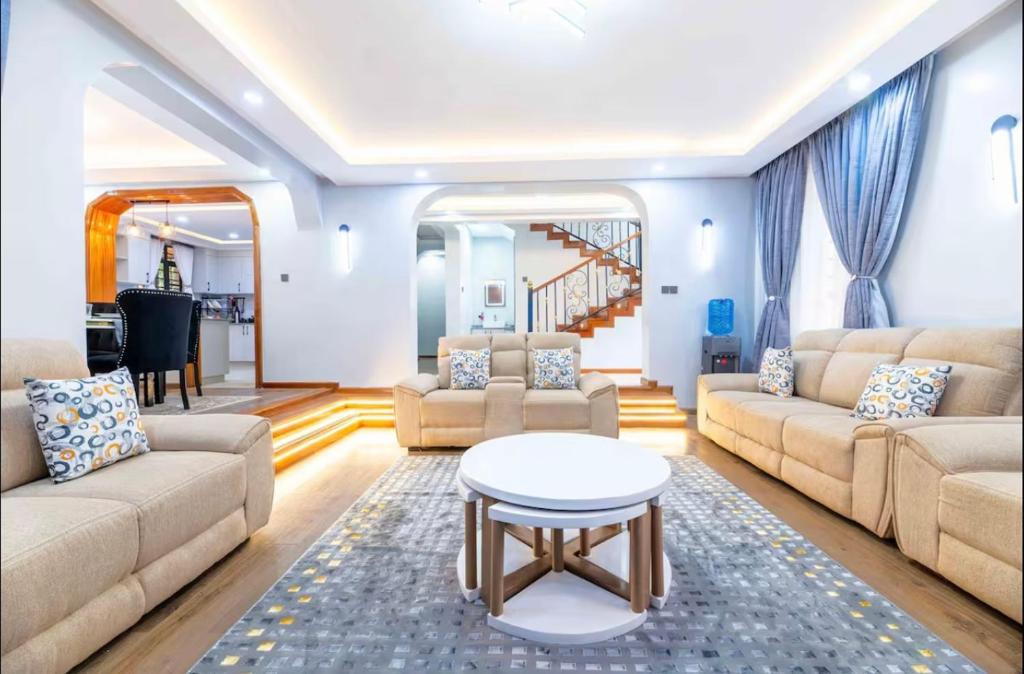 a living room with two couches and a table at Emerald Greens 3-Bedroom House in Thika