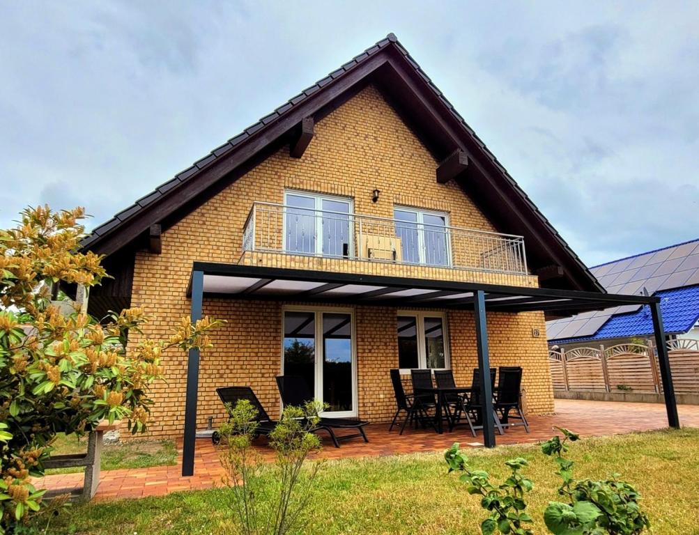 a brick house with a balcony and a patio at Ferienwohnung am Plauer See in Alt Schwerin