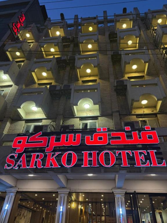 Un cartel en el frente de un hotel de sakura en Sarko hotel فندق سركو, en Baghdād