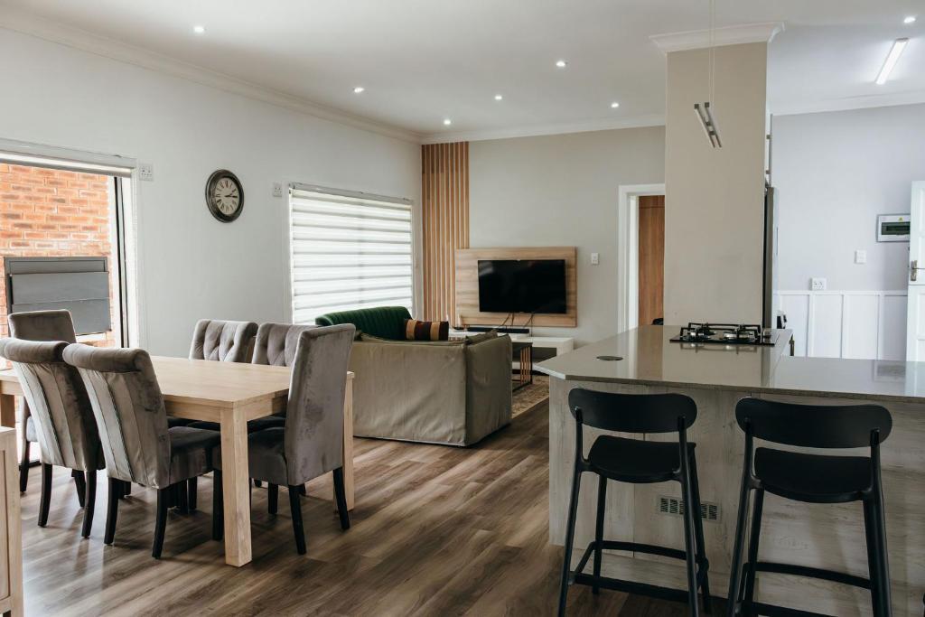 a kitchen and living room with a table and chairs at Disa Close 3 Cathkin Estates in Winterton