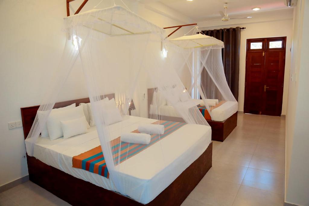 En eller flere senge i et værelse på Urban Tide Dickwella