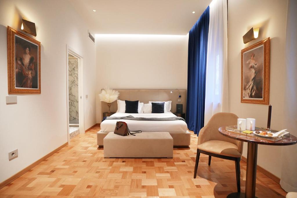 a hotel room with a bed and a table at Duse Luxury Stay in Milan