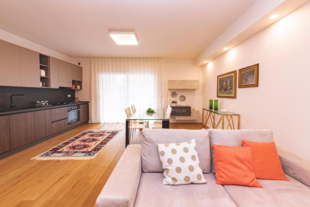 a living room with a couch and a kitchen at VITTO Luxury Apartment in Lecce