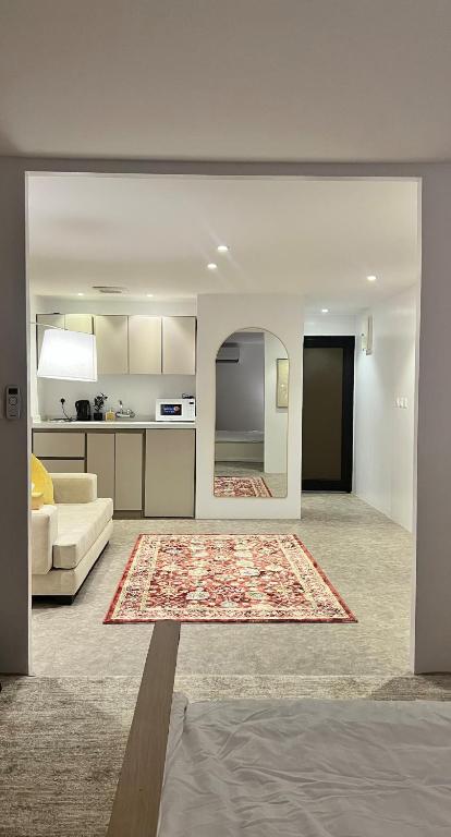 En eller flere senge i et værelse på The Pearls Apartment