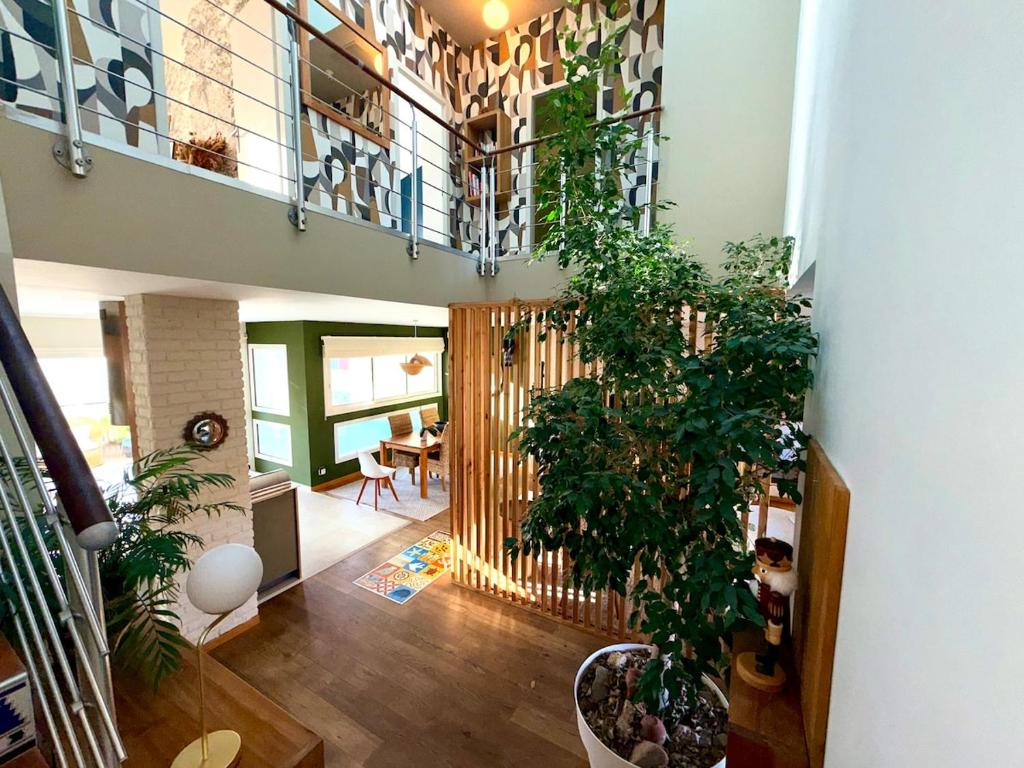 a room with a staircase with plants in it at Urban Oasis - Duplex Design, Piscine privée in Perpignan
