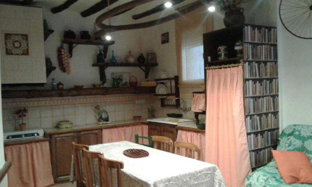 a kitchen with a table and chairs and a table and a tableablish at Casa Elina Lucena in Lucena del Cid