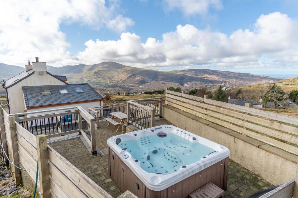 a hot tub on the roof of a house at Groeslon Uchaf in Caernarfon