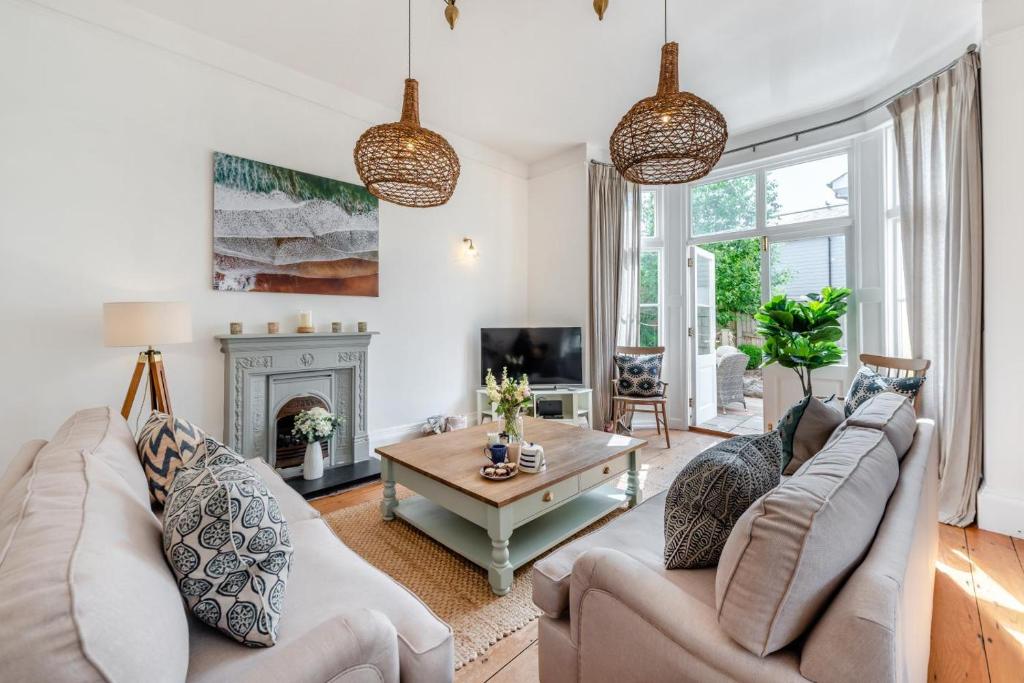 a living room with two couches and a fireplace at 4 Bed in Instow oc-clevv in Instow