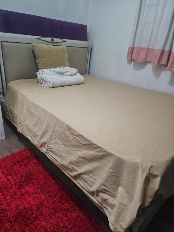 En eller flere senge i et værelse på Casa compartida en Munro