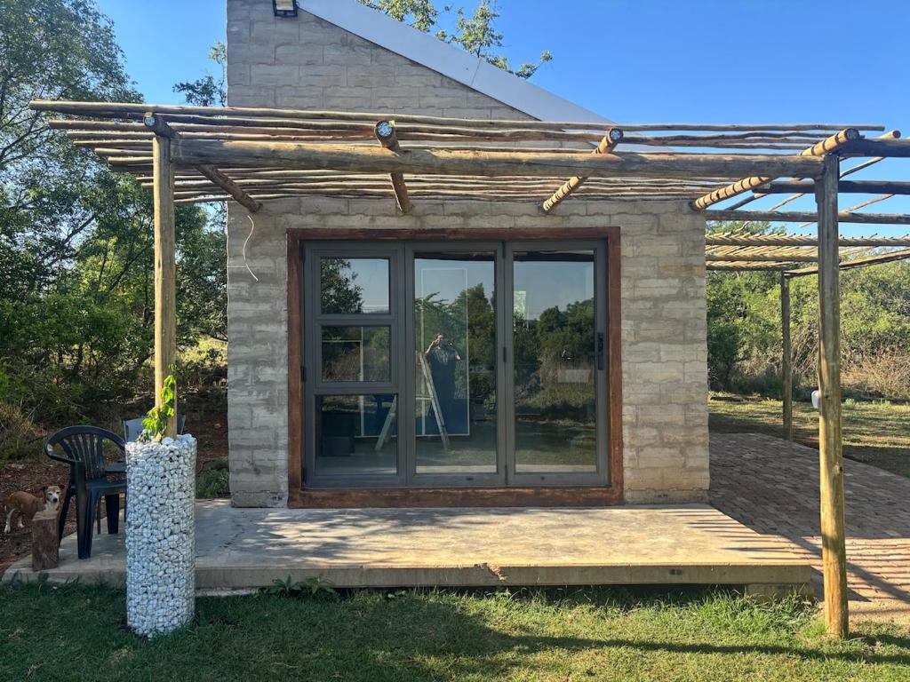 a small house with a woman in the window at Bosch Rest in Pretoria