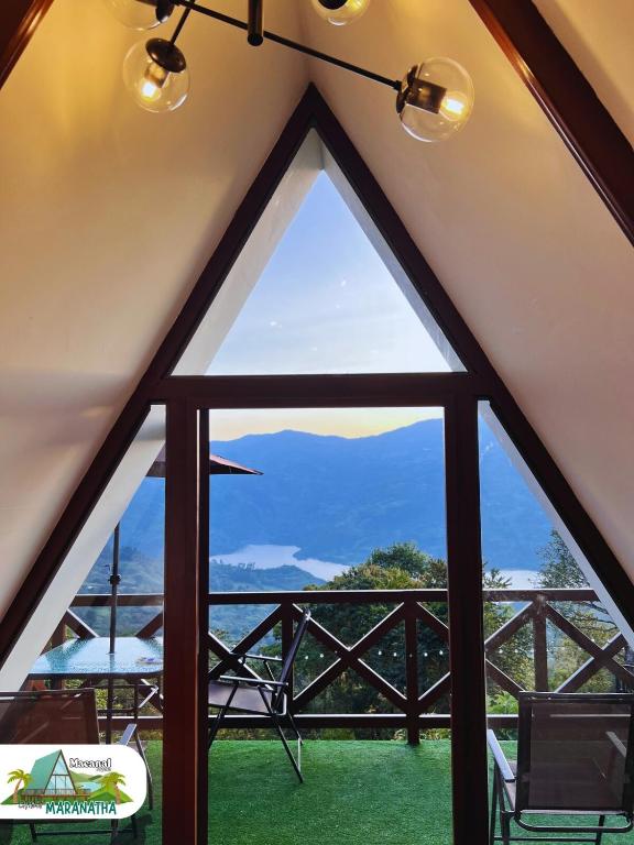 a view from the inside of a tent with a window at Chalet Maranatha Vista Única Represa de Chivor in Macanal