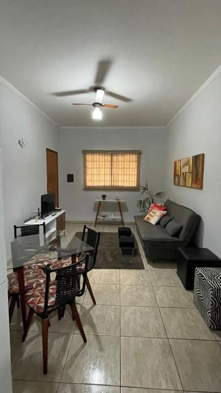 a living room with a couch and a table at Casa Gêmeas 1 in Andradina