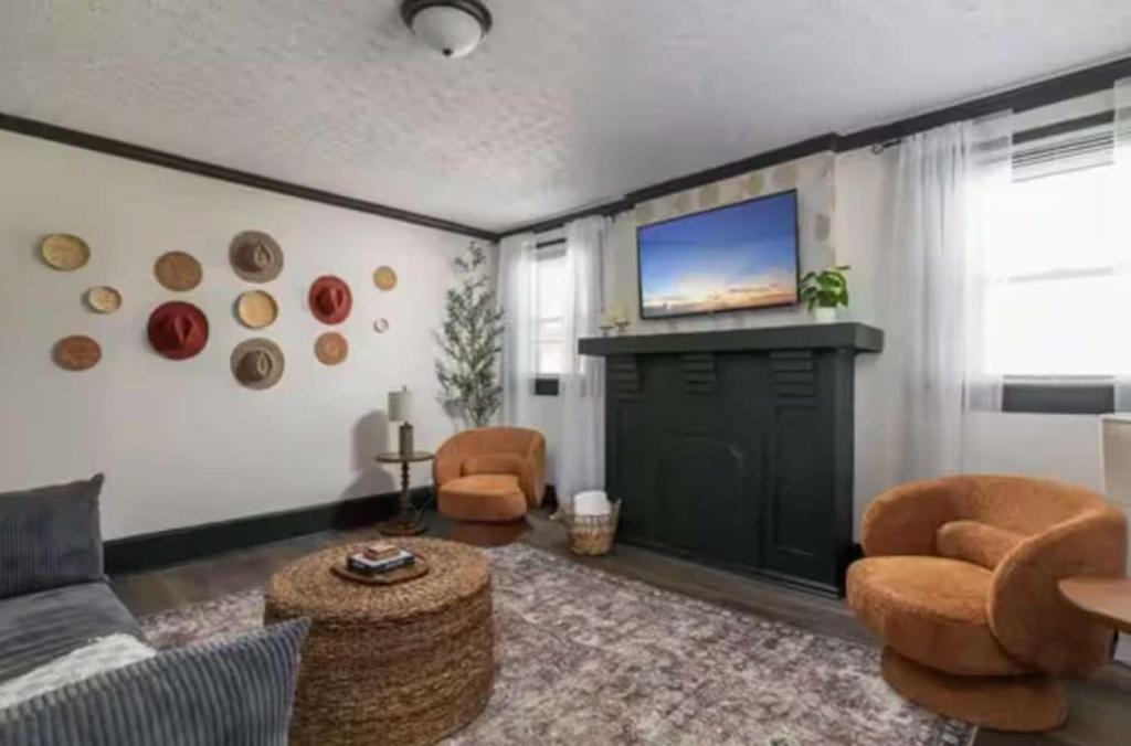 a living room with a couch and a flat screen tv at 3BR Downtown-Old Salem Oasis in Winston-Salem