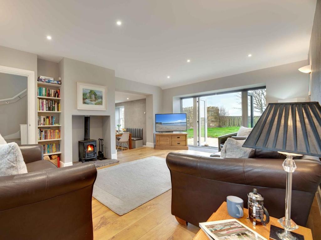 a living room with a couch and a fireplace at 3 Bed in Beadnell oc-cn113 in Beadnell