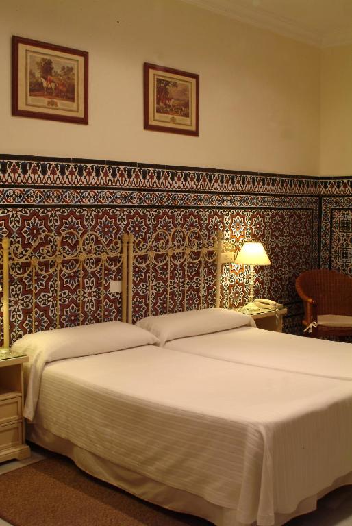 Posteľ alebo postele v izbe v ubytovaní Hotel Simon