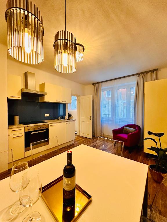 a kitchen with a table with a bottle of wine on it at Red Room in Schottwien