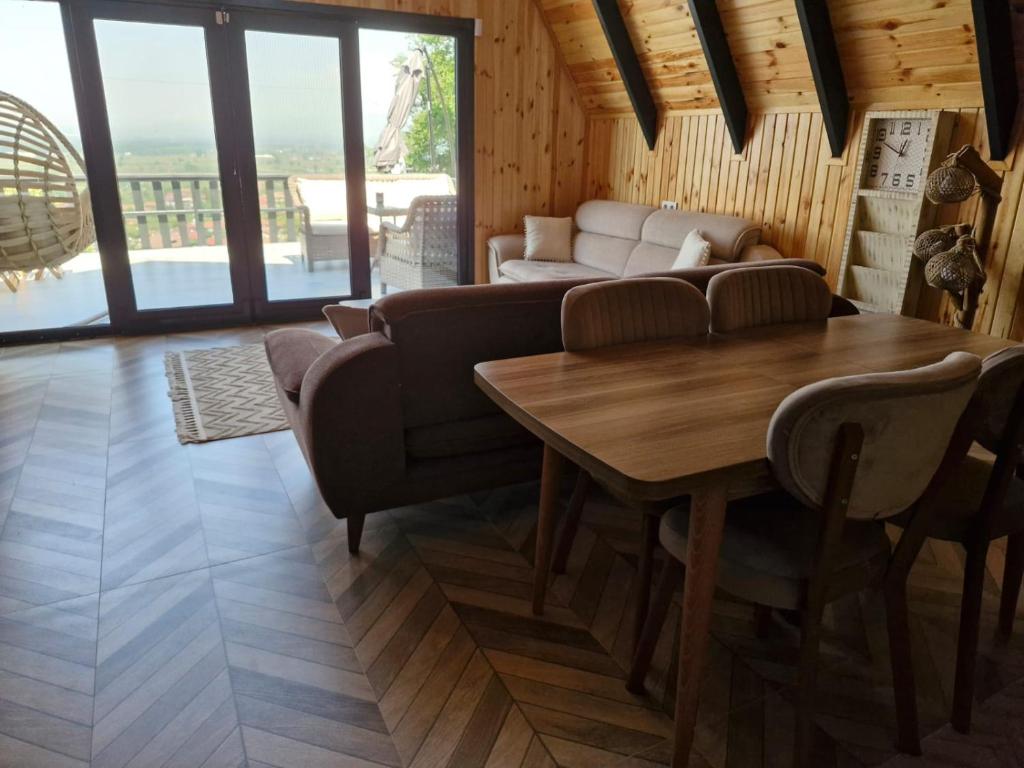 a living room with a couch and a table at YAKUT bungalow in Akyazı