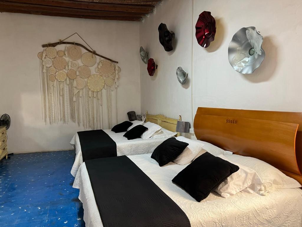 two beds are in a room with blue floors at Casa Díaz Habitacion Diamante in Parras de la Fuente