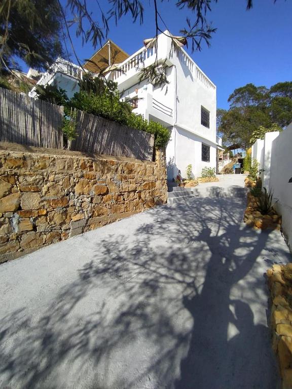 a shadow of a tree in front of a building at Rif House MEDIOUNA in Tangier