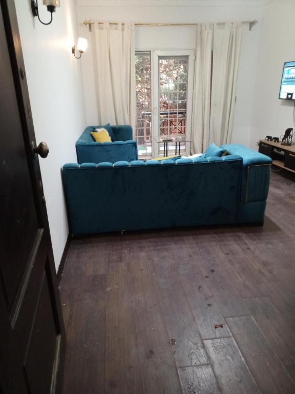 a blue couch sitting in a living room at مصر مدينة الشيخ زايد in Sheikh Zayed
