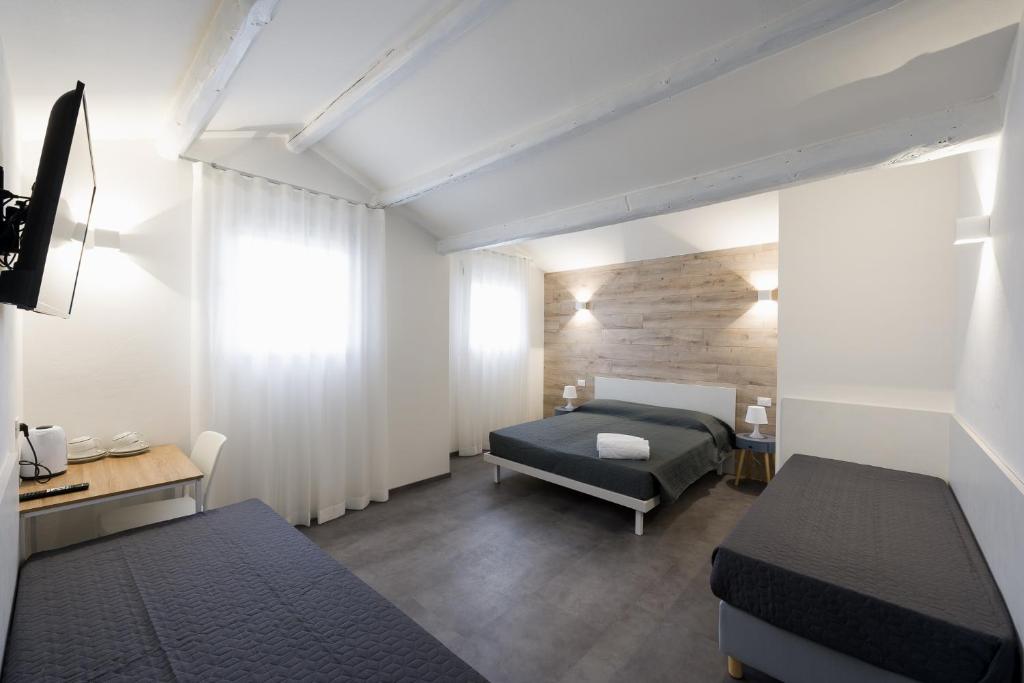 En eller flere senge i et værelse på Boutique Hotel Nuovo Cason