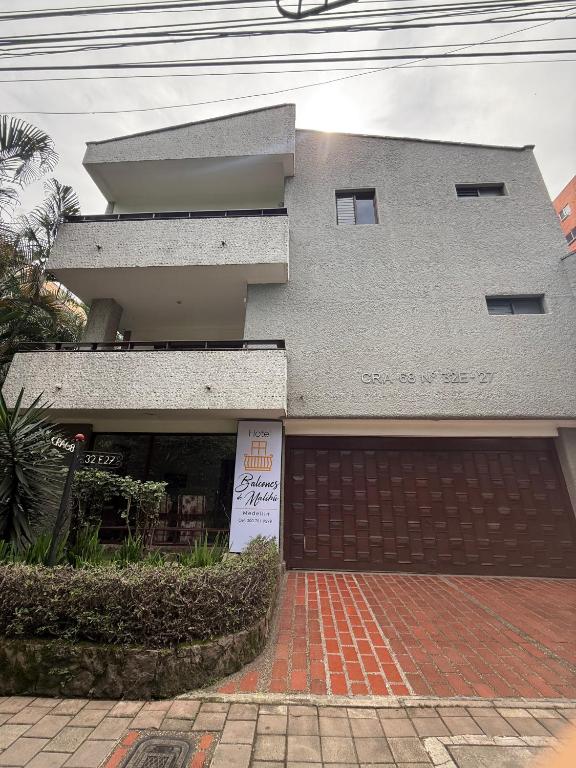 a building with a sign in front of it at Hotel Balcones De Malibu in Medellín