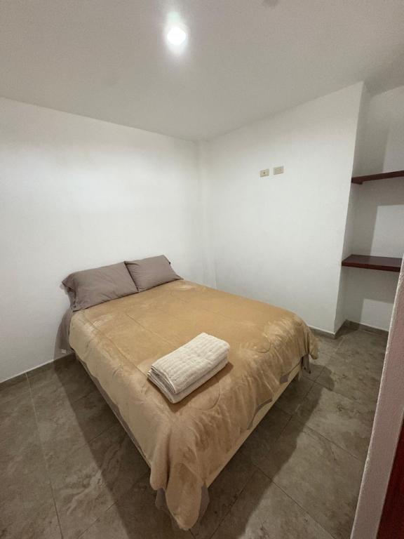 a bedroom with a bed with a blanket on it at Alcalá in Atlixco