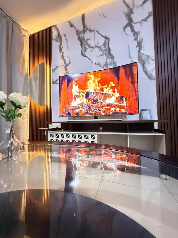 a living room with a tv and a table at Opera47 Spacious & Central in Ghubrah