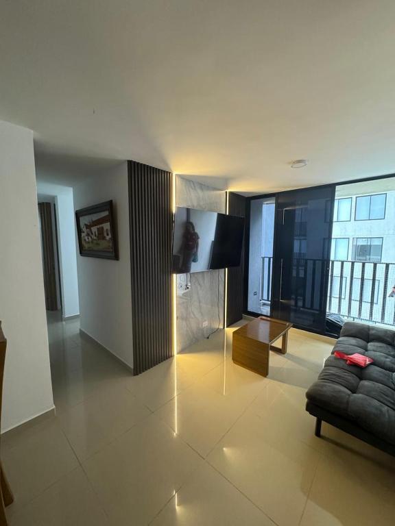 a living room with a couch and a flat screen tv at APARTAMENTO Premium in Ibagué