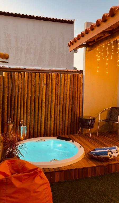 a hot tub in the middle of a patio at Pousada Alkamar in Maragogi