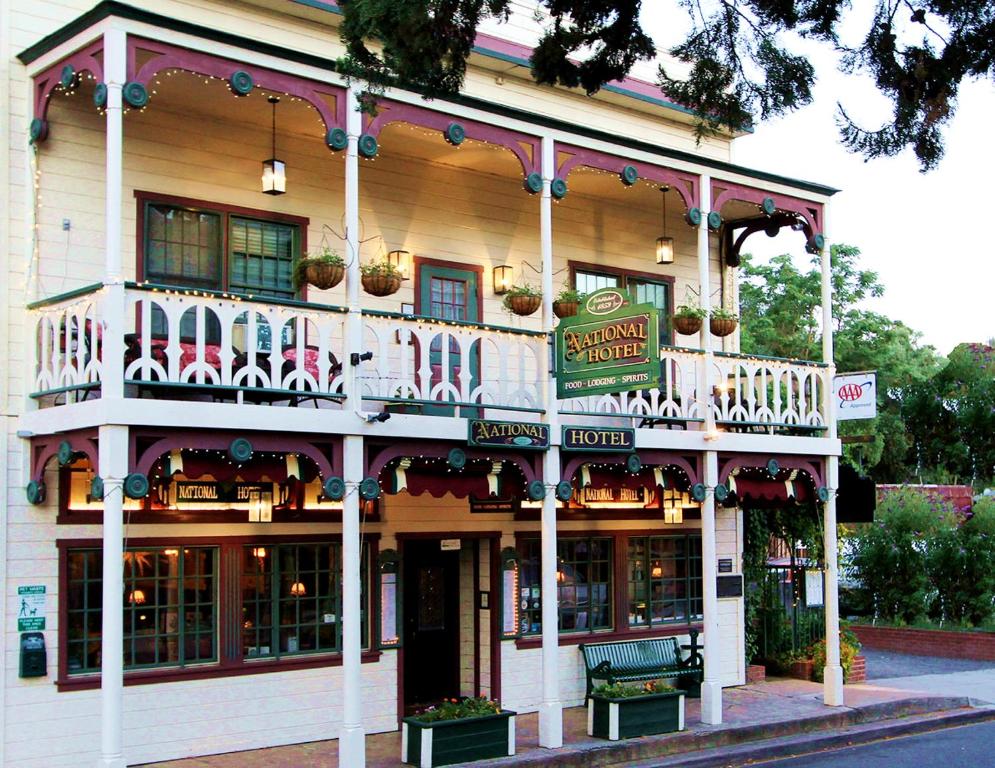 a large building with a balcony on a street at The National Hotel in Jamestown