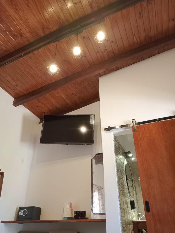 a television hanging from a ceiling in a room at El descanso de la Furia in La Porteña