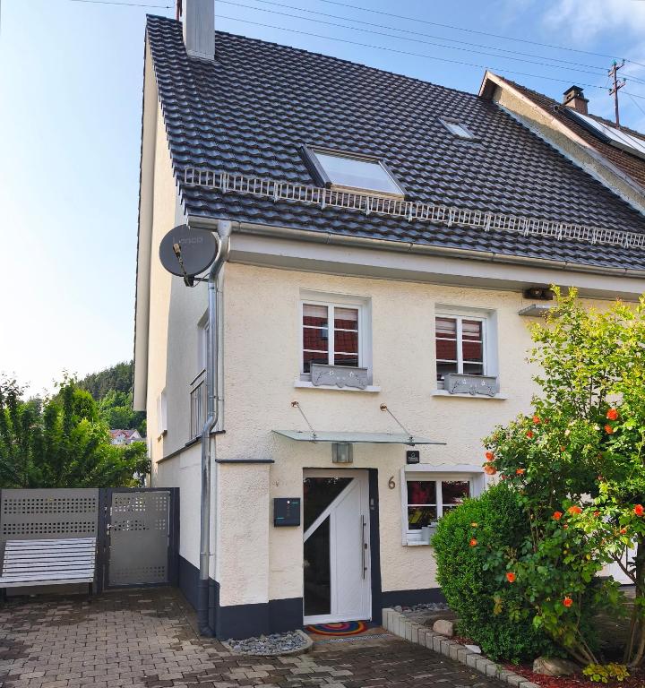 a white house with a white door and a gate at Tieringer Landglück in Meßstetten