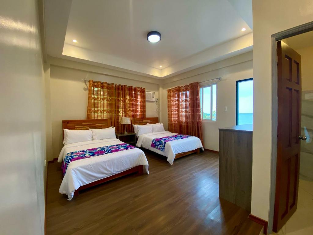 una camera d'albergo con due letti in una stanza di Bay Bay Beach Resort 