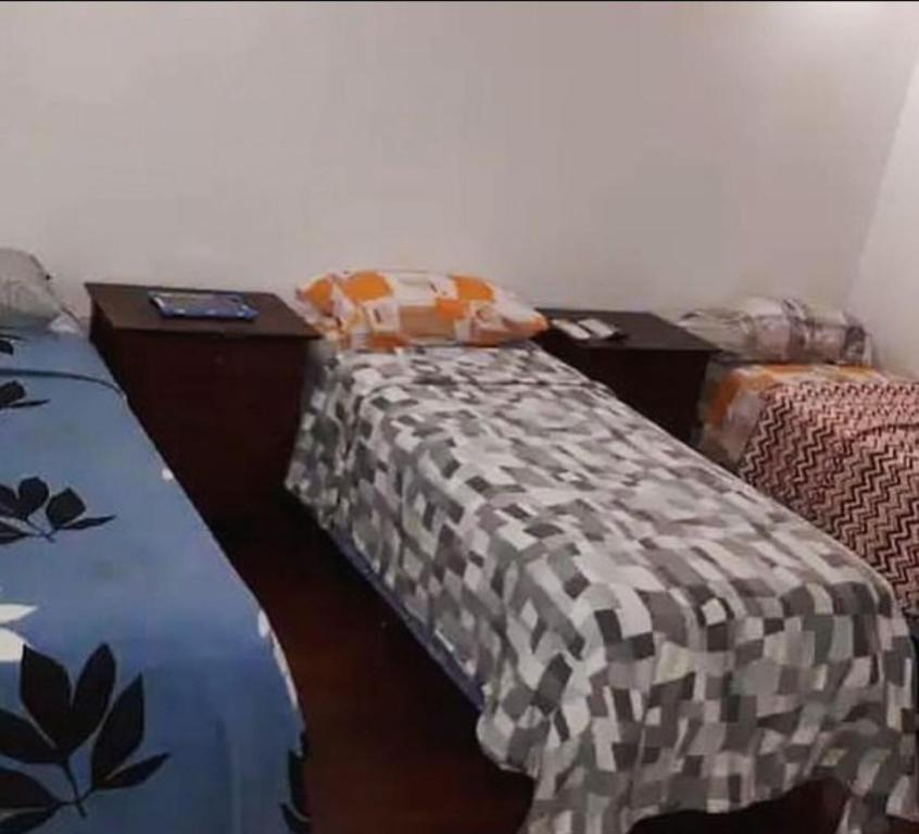 una camera da letto con due letti e due comodini di Benjamín Relax a Victoria