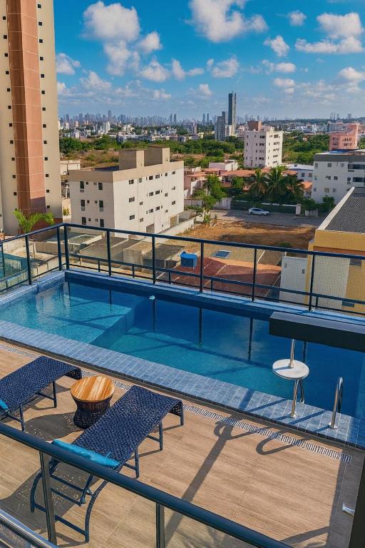 a balcony with a swimming pool on top of a building at Flat com piscina na cobertura em Intermares in Cabedelo