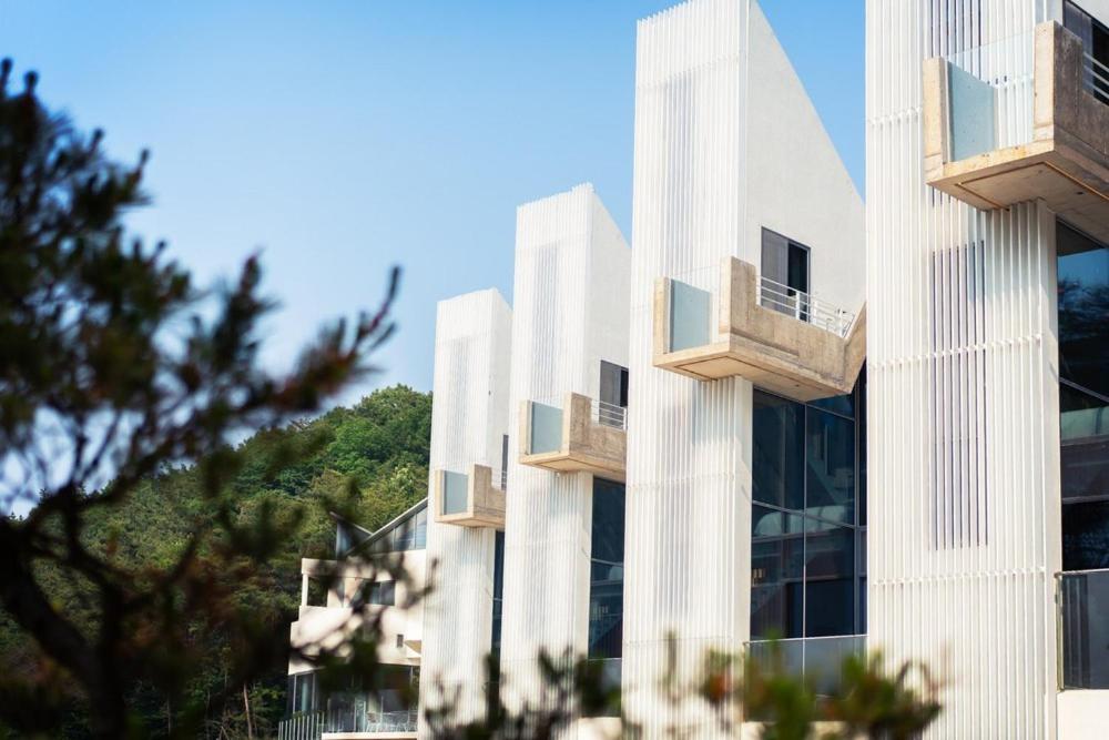 a white building with balconies on the side of it at Buan Intaglio Pool Villa in Buan