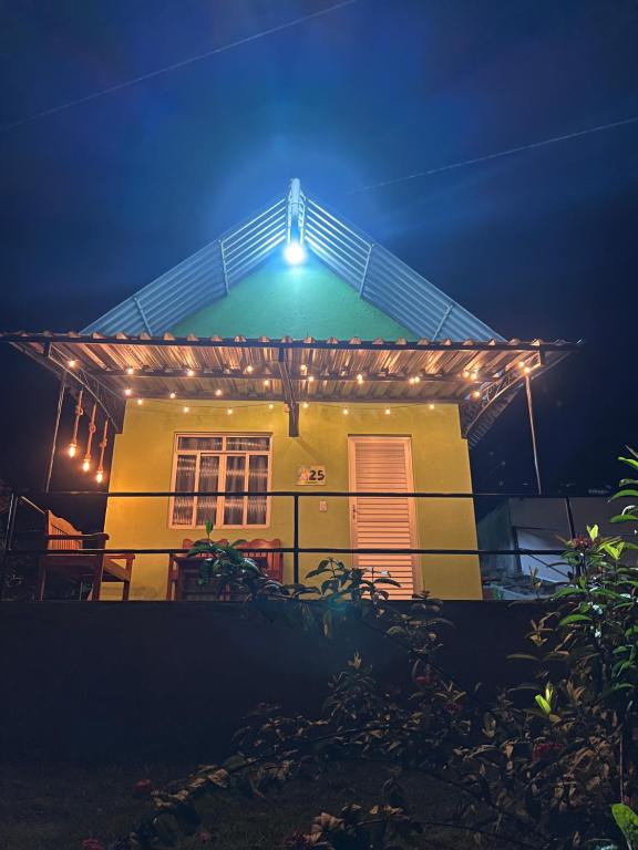 a house with a light on the roof at night at Chalé em Parque Aquático - Presidente Figueiredo in Presidente Figueiredo