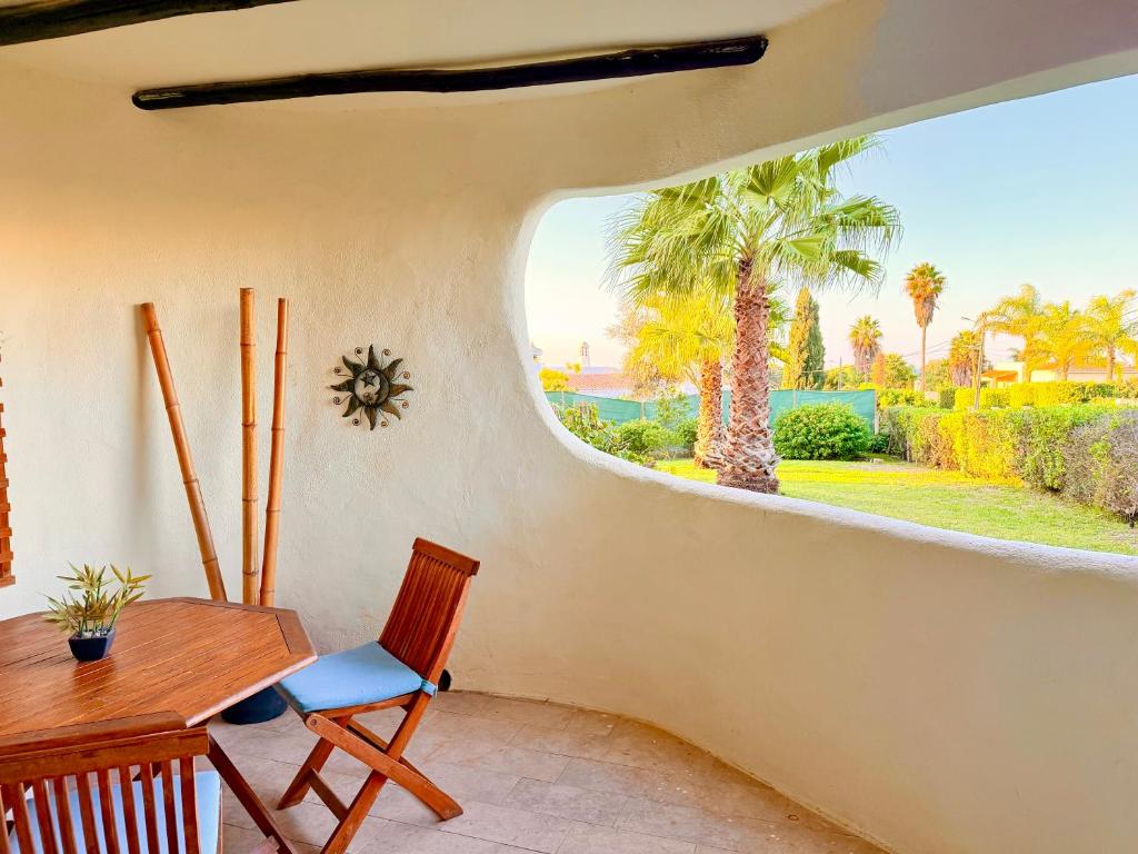 a dining room with a table and a window at Casa Flor de Sal Apartment in Carvoeiro