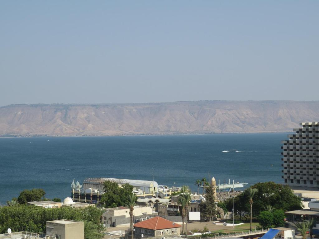 a view of the ocean from a city at Agas Holiday Apartments Family in Tiberias