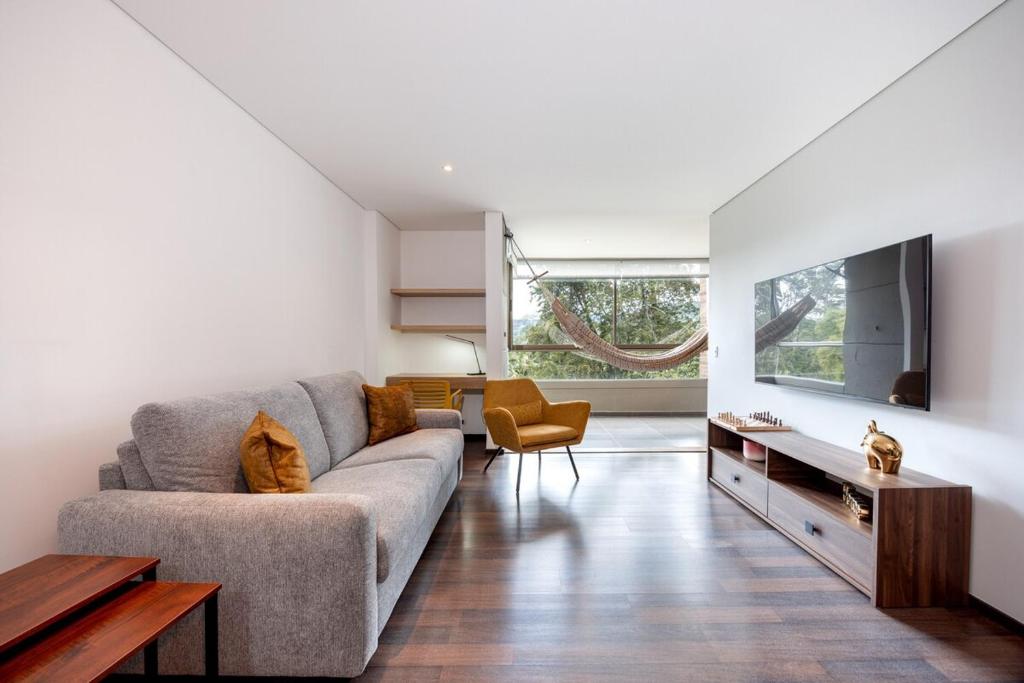 a living room with a couch and a tv at Apartamentos Casa Grande in Rionegro
