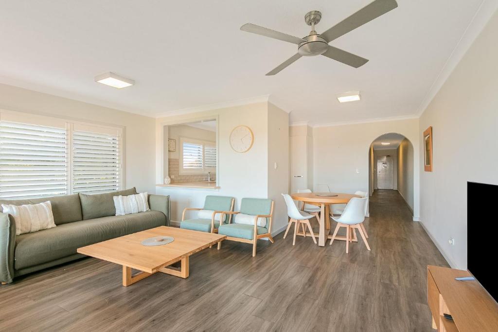a living room with a couch and a table at Endless Horizon in Kingscliff
